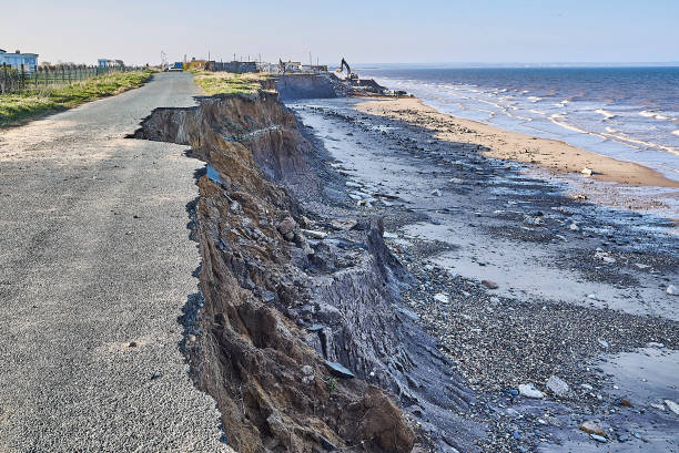 A road collapsing into the sea due to severe coastal erosion